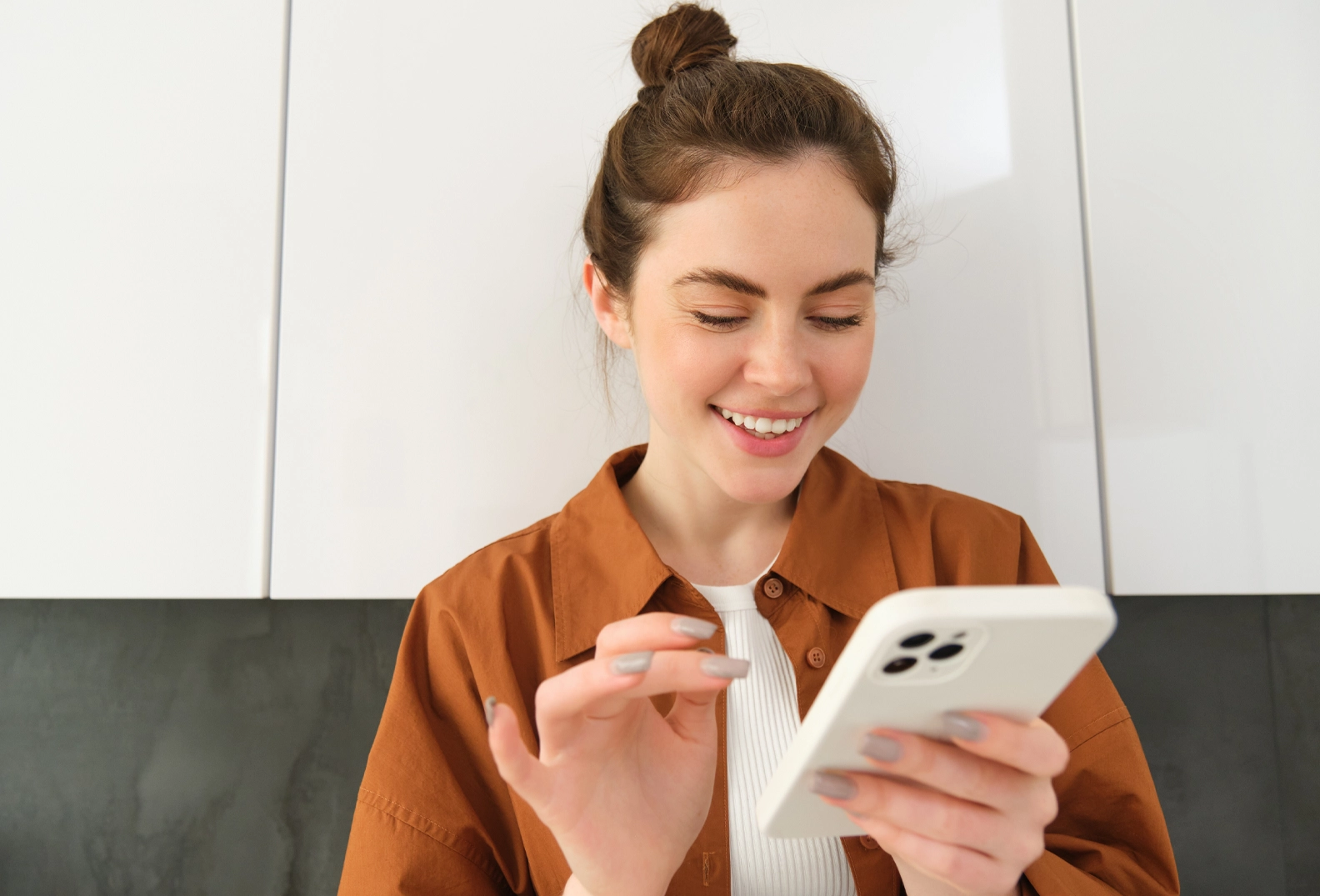 Woman holding her smartphone in her hand and tapping the screen
