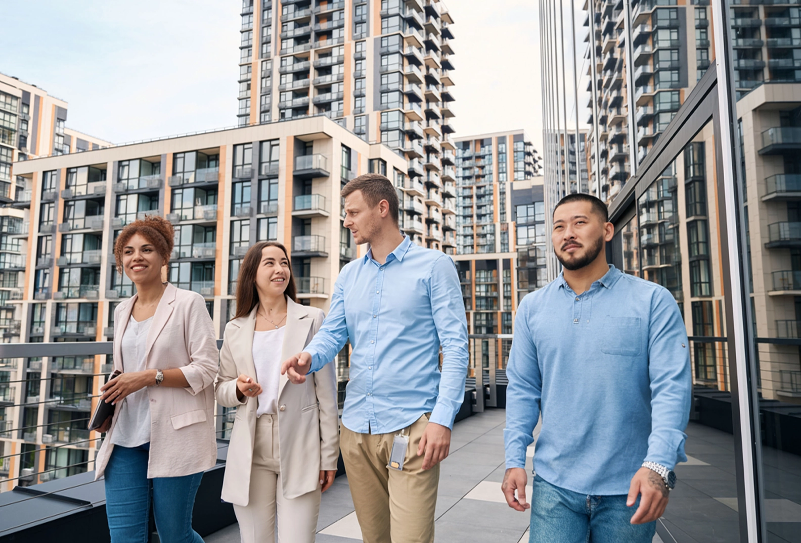 A group of four people walking on a balcony