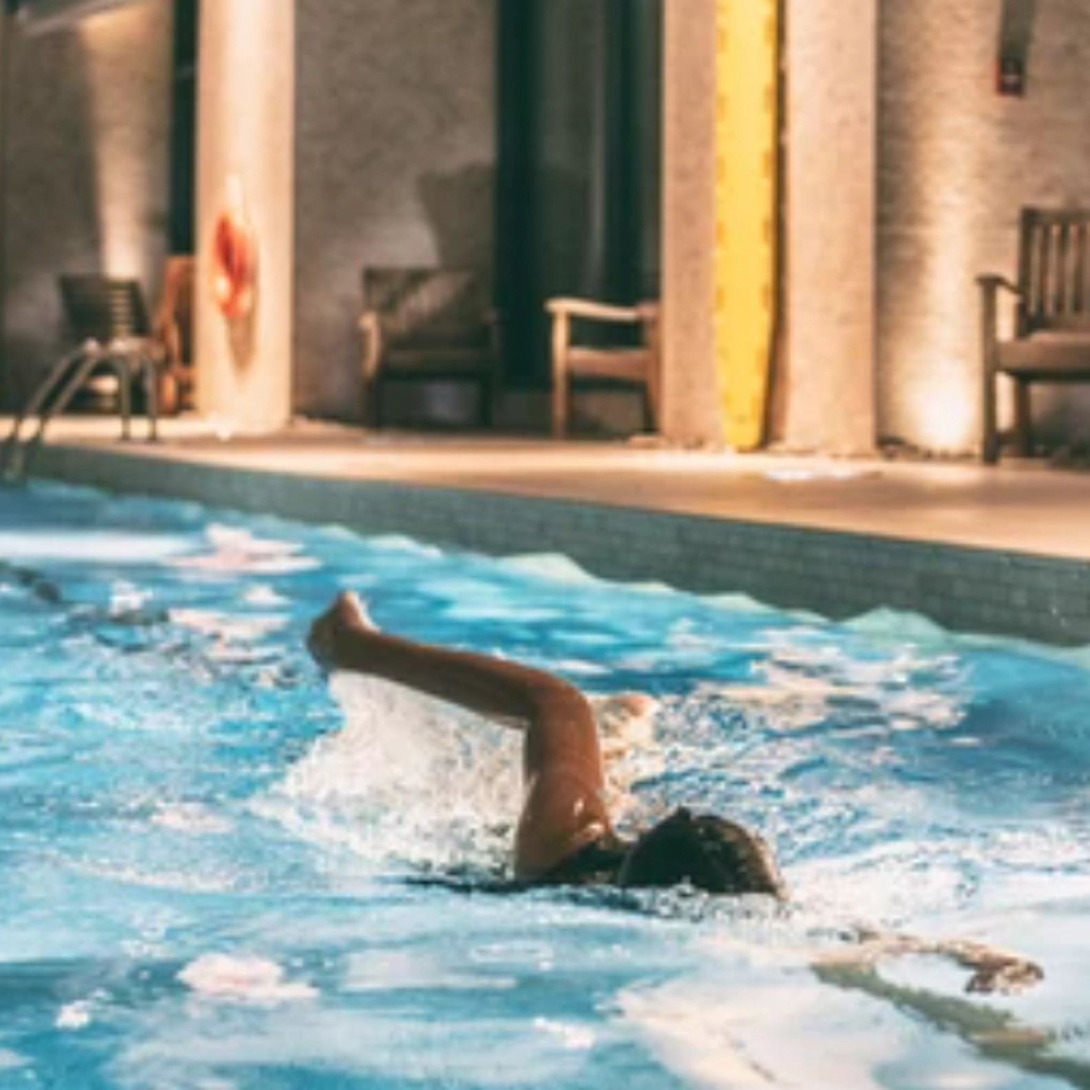 Person swimming in a pool