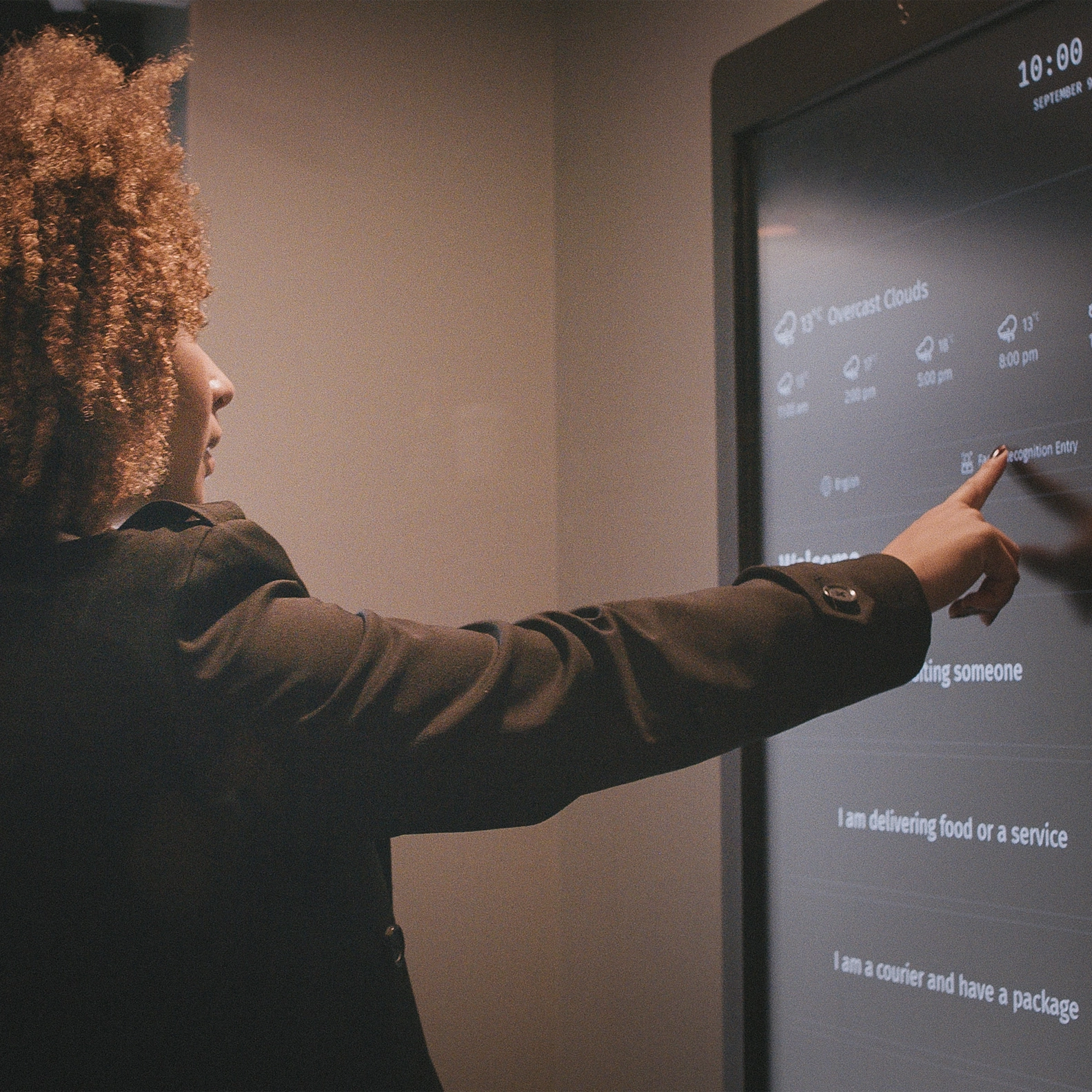 Woman using the facial recognition entry on 1VALET's smart entry system