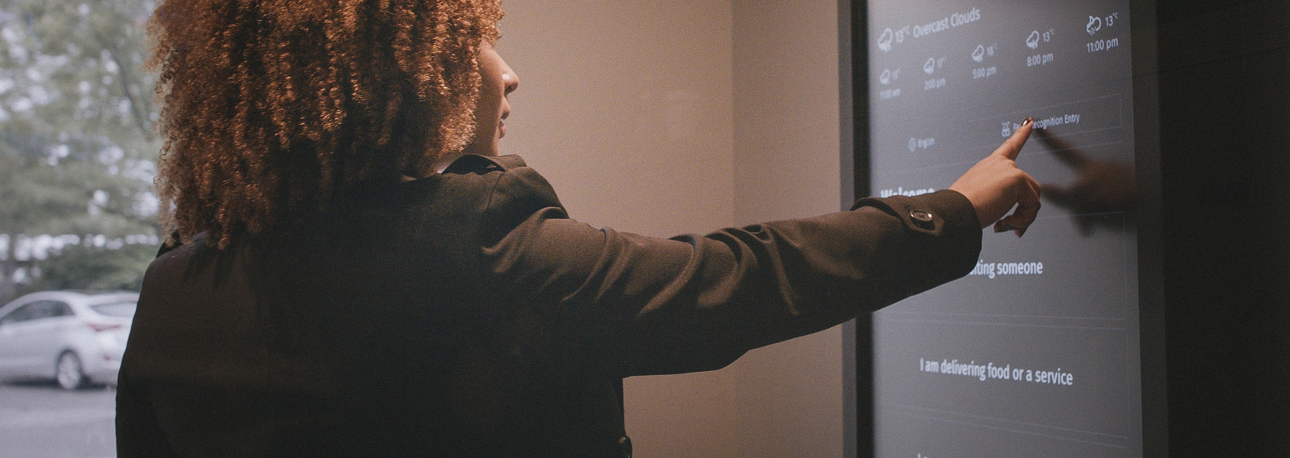 Woman using 1VALET's smart video entry system