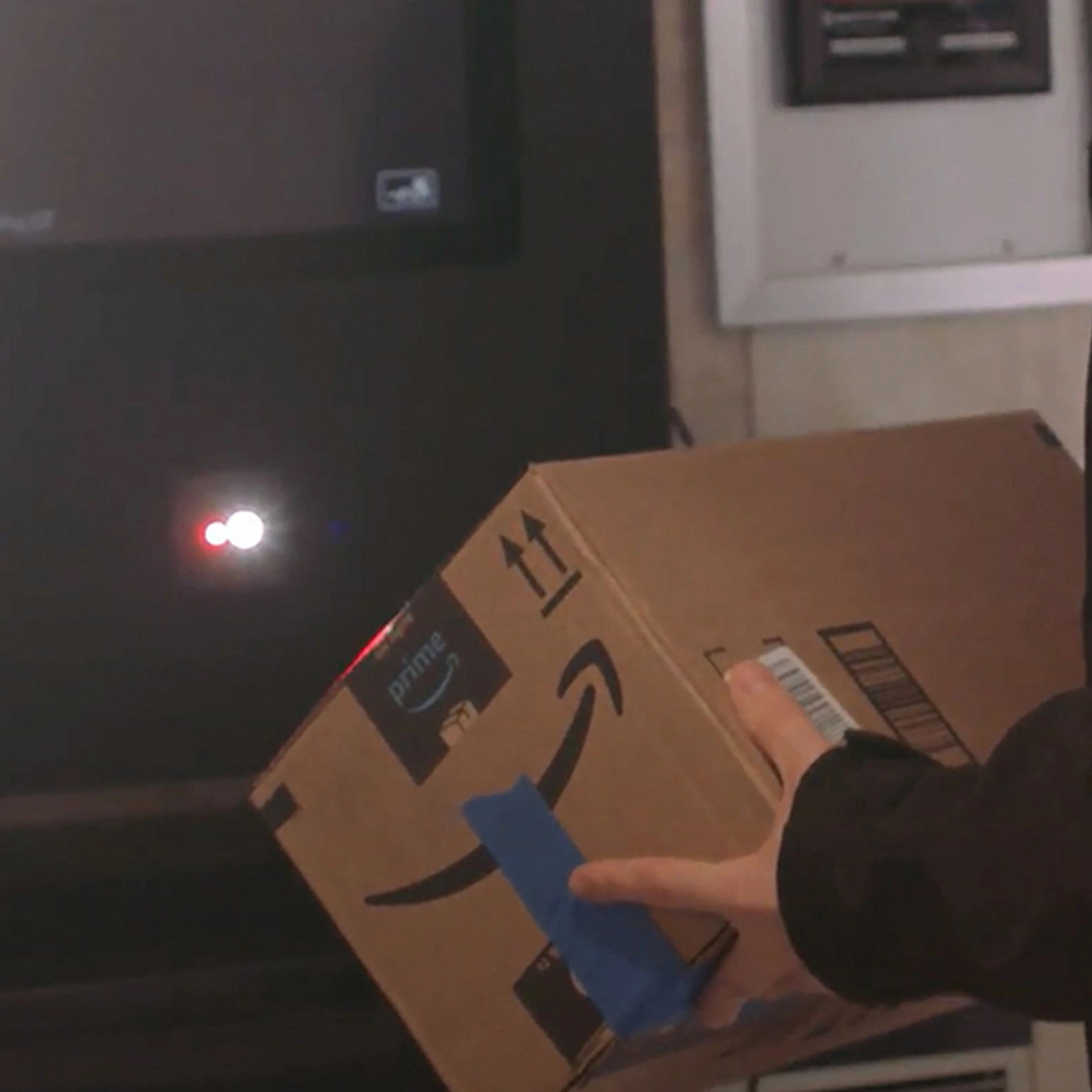 Person carrying a Amazon delivery