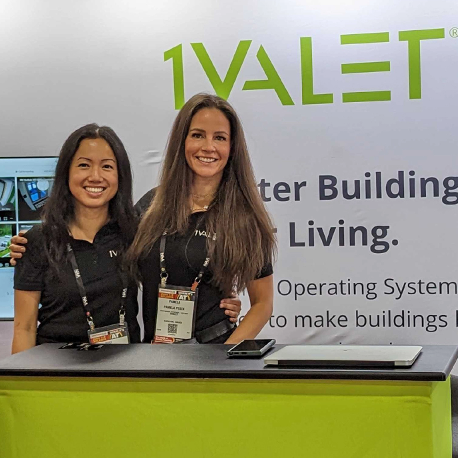 Two women at a 1VALET booth at a tradeshow