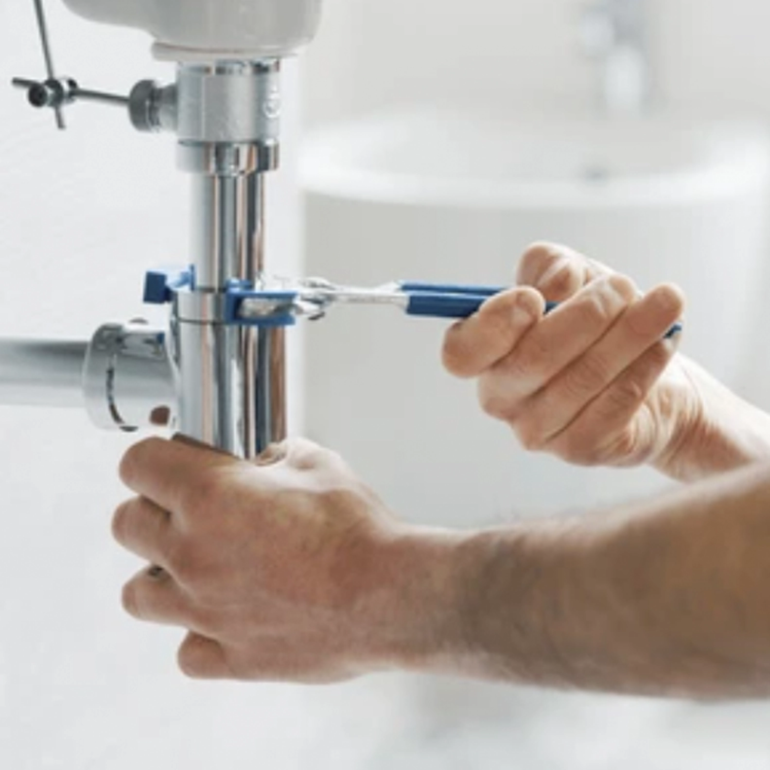 Service repair technician repairing drain on sink