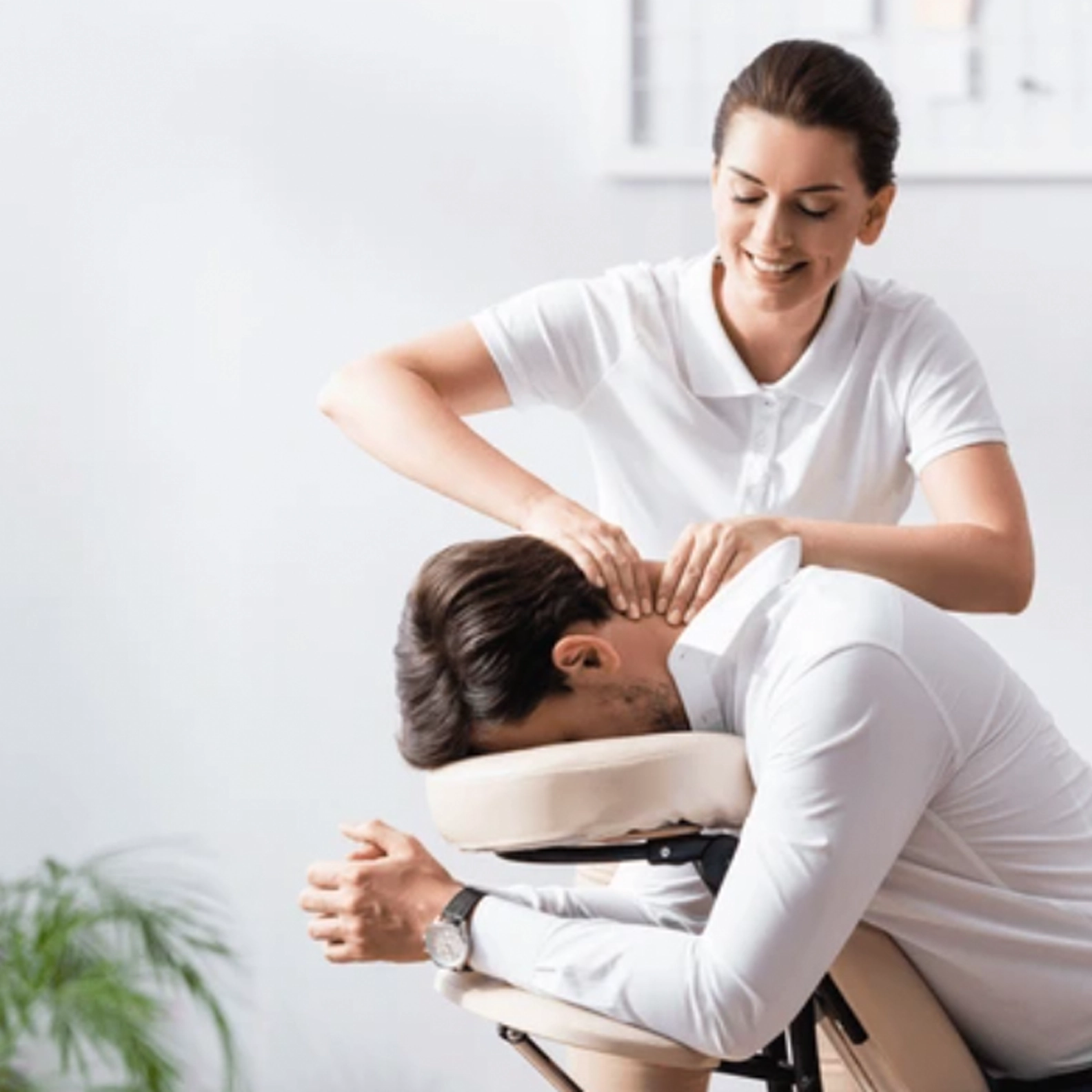 Massage therapist massaging a man's neck