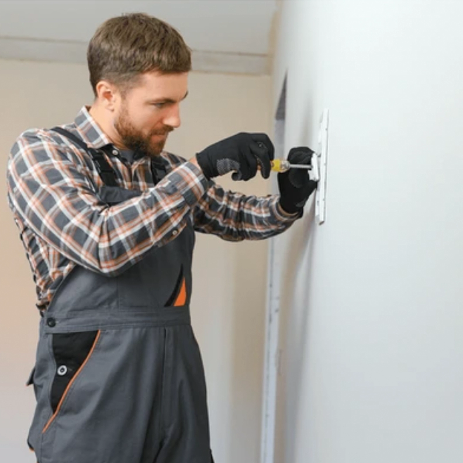 Man fixing something on the wall