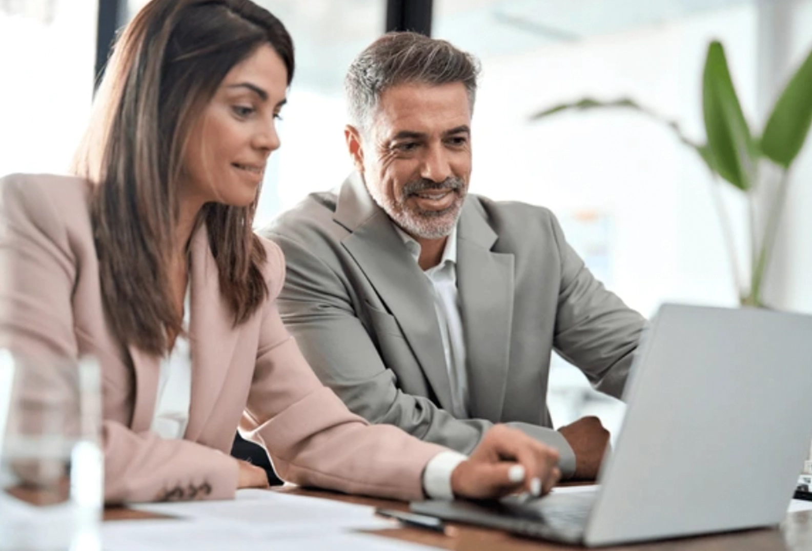 Woman and Man in business attire working at a computer